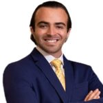 Smiling professional in navy suit and yellow tie